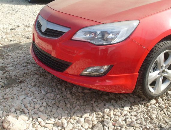 Передня нижня накладка 2010-2012 (під фарбування) для Opel Astra J 2010↗ рр.