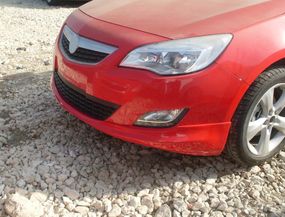 Передня нижня накладка 2010-2012 (під фарбування) для Opel Astra J 2010↗ рр.