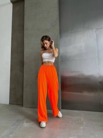 Женские яркие спортивные штаны-палаццо оверсайз SH400 цвет неоновый оранжевый, размер onesize 42/46
